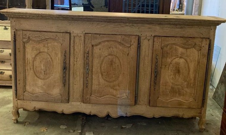 A late 18th century French provincial bleached oak three door buffet, length 244cm, depth 46cm, height 133cm